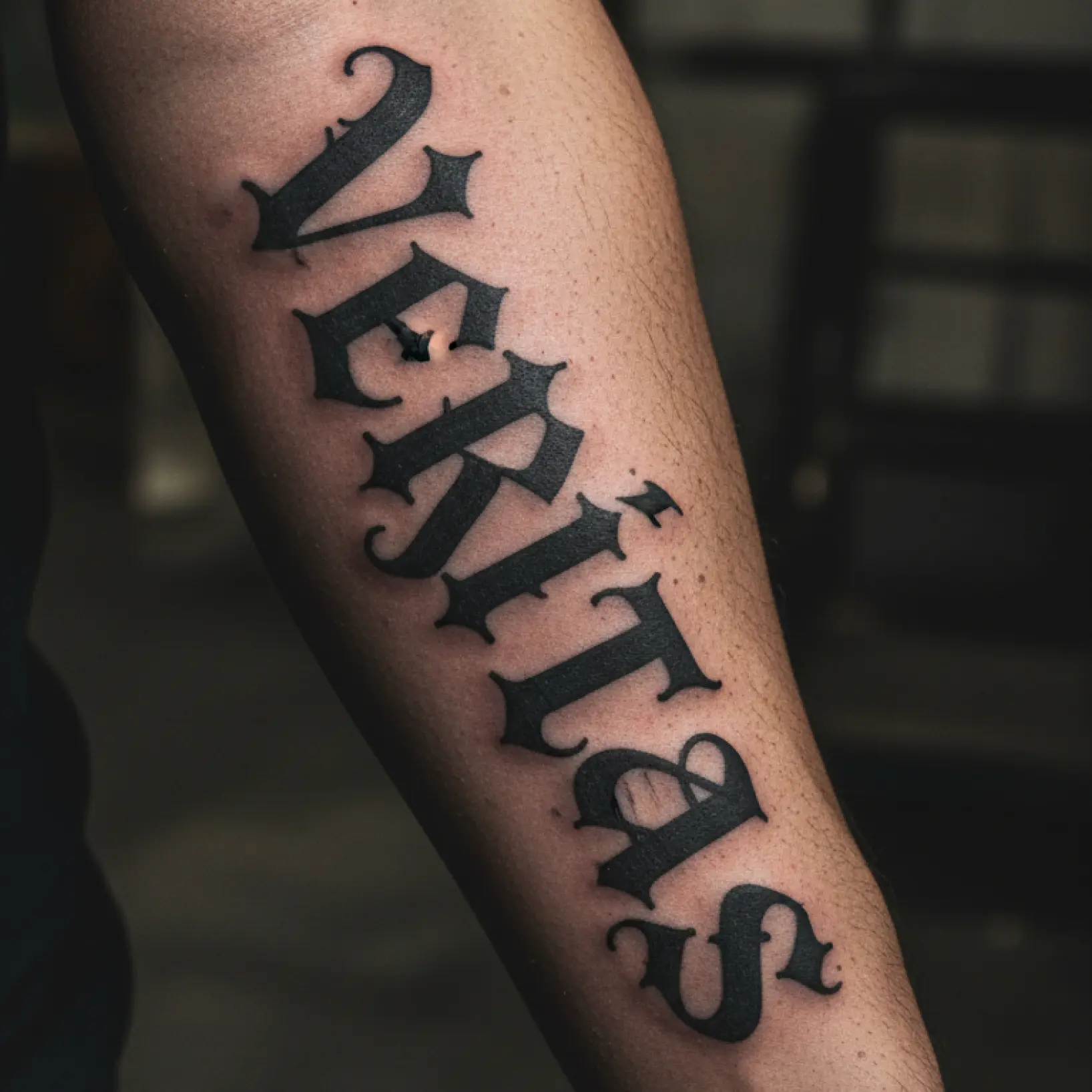 Tattoo font generator showing custom script design previewed on arm