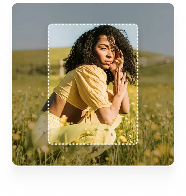 Woman in a flower field An image of a woman crouching in a field of yellow flowers with a dotted frame around her, suggesting a tool for extending or editing images